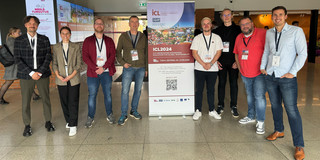 The project team next to the conference poster