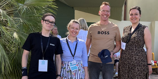 Sabine Lauer, Olga Wagner, Uwe Wilkesmann, Ronja Vorberg at the EGOS Conference. Wilkesmann wears a T-shirt, cap and necklace with the word "Boss" to match the title of the lecture.