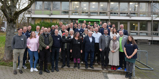 Group photo of participants in front of the venue.